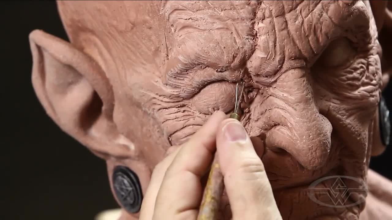 Bruce Spaulding Fuller adds finishing touches to the witch's scar.