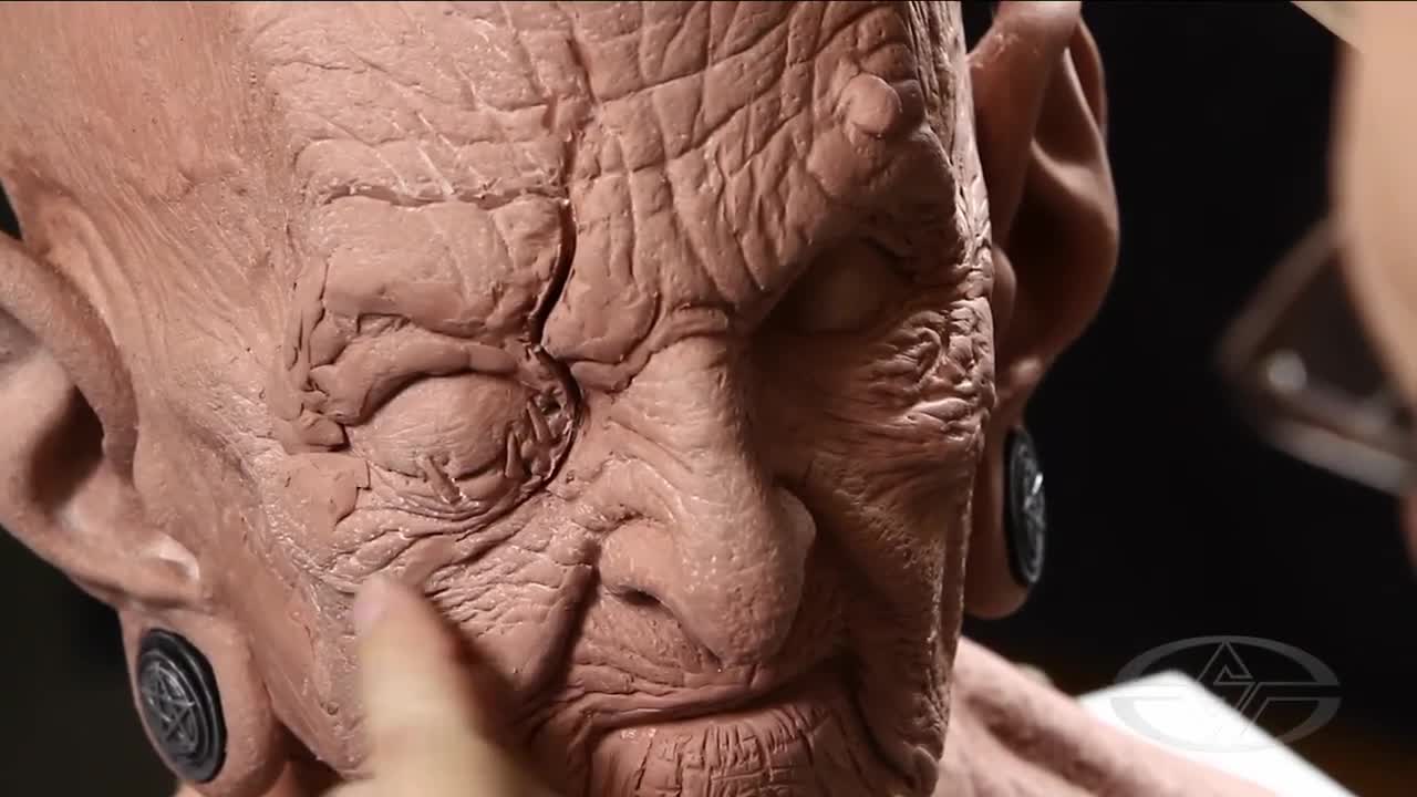 Bruce Spaulding Fuller begins to add clay and blend to areas surrounding the eye to give it a seamless appearance.