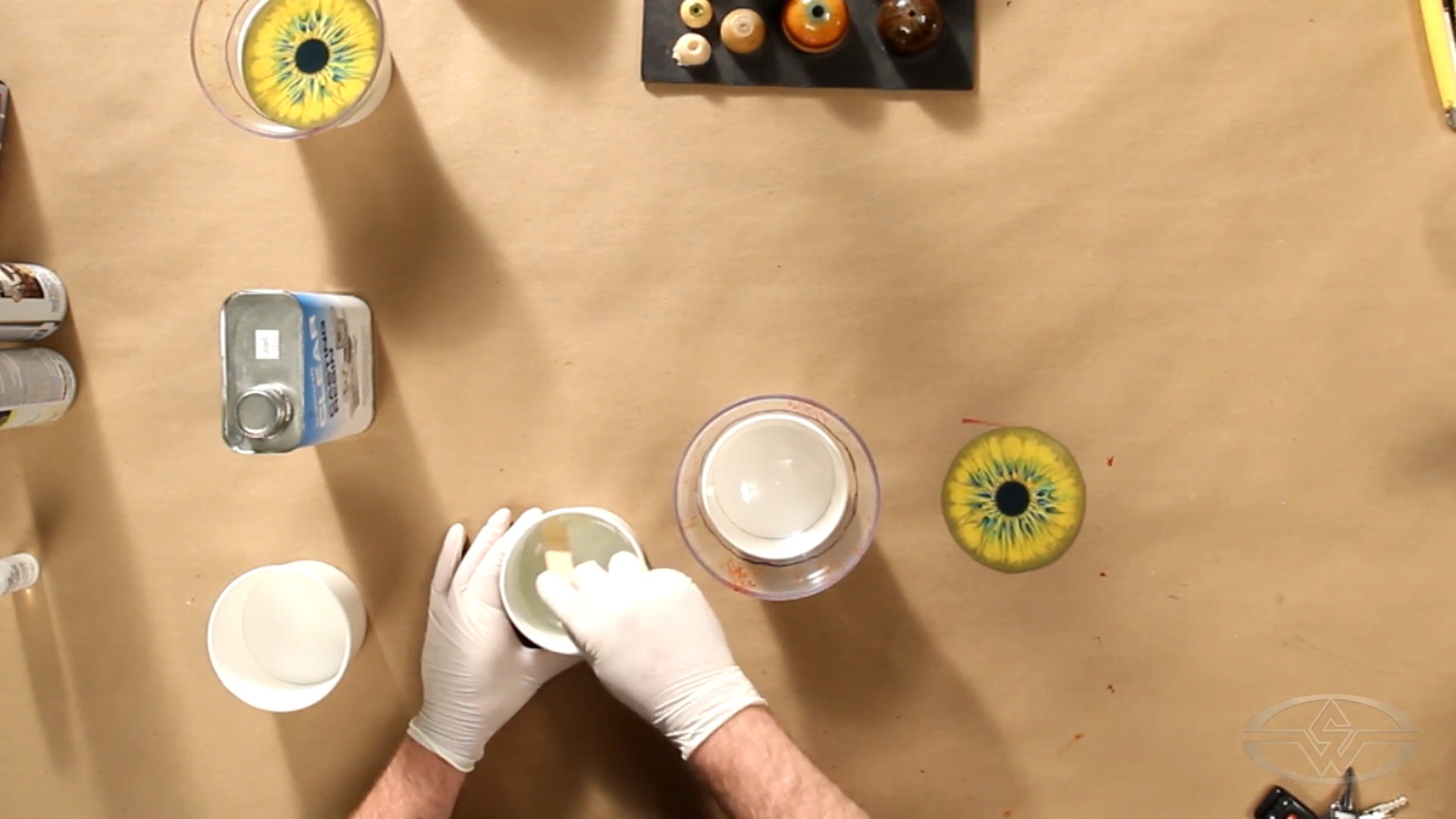 Haines stirs slowly, mixing the resin and catalyst to reduce the amount of air bubbles.