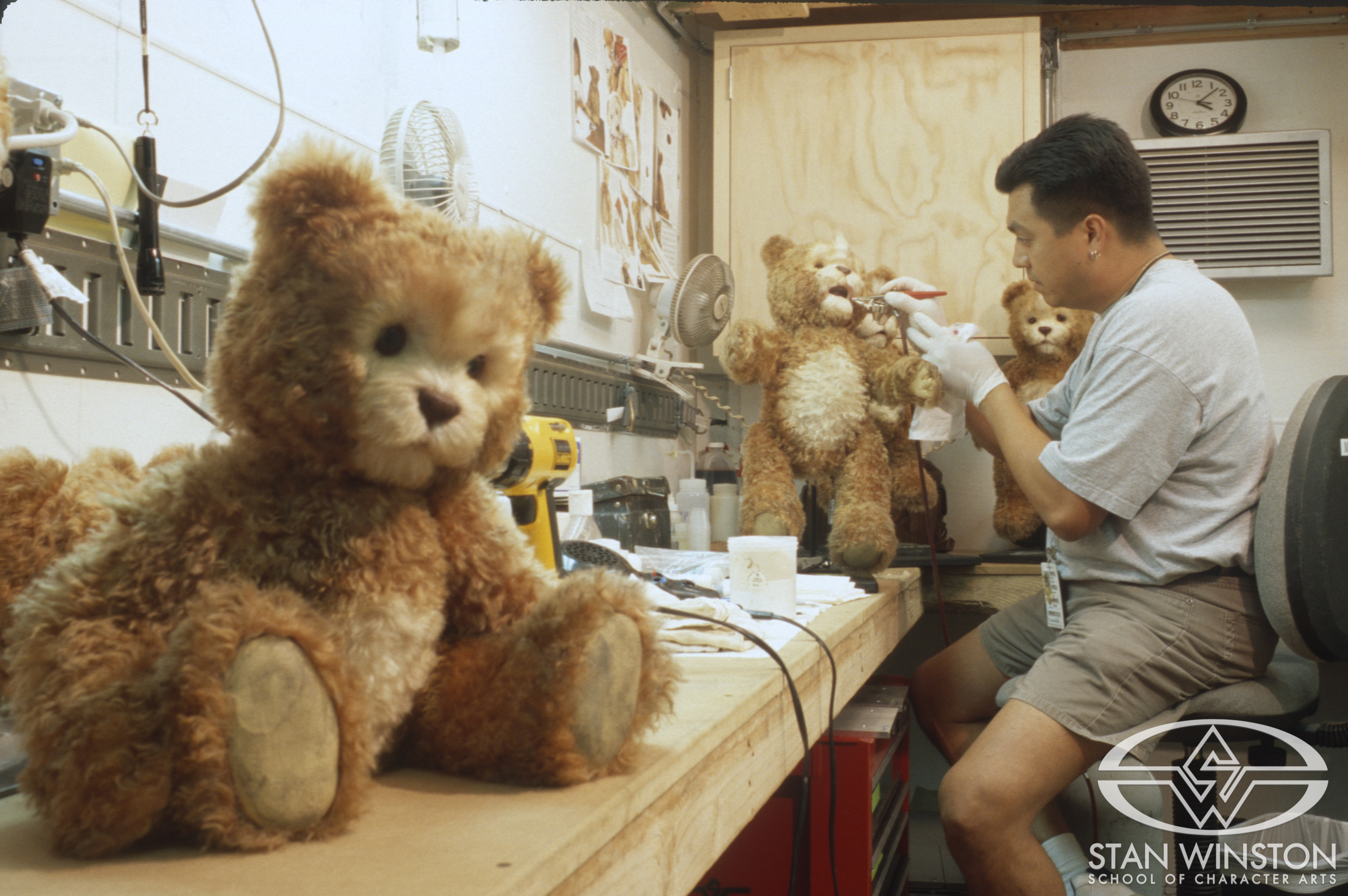 Michael Ornelaz airbrushes one of the Teddy puppets.