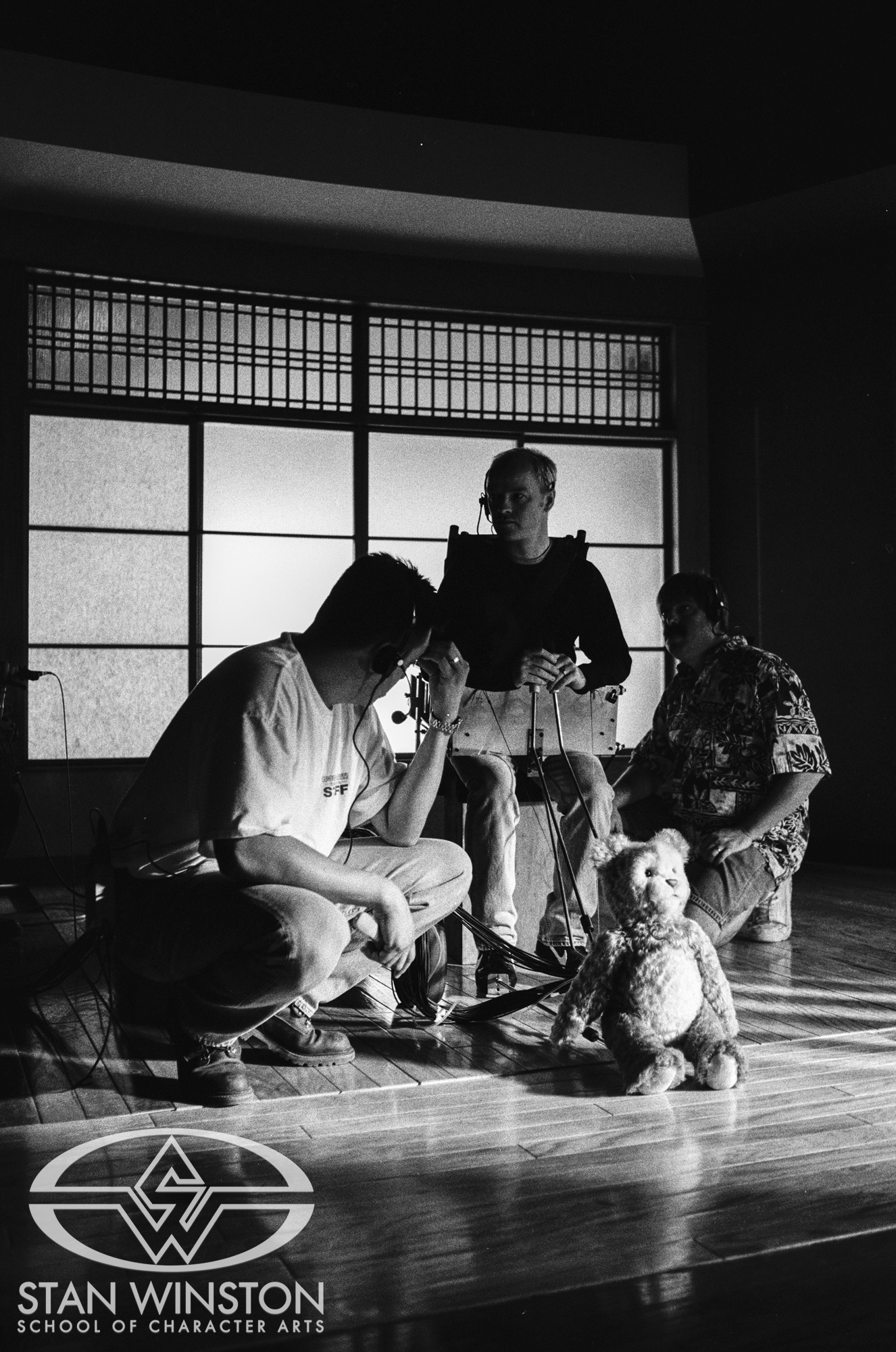 Eric Fiedler, Lindsay MacGowan, and Michael Ornelaz practicing Teddy walking on set.