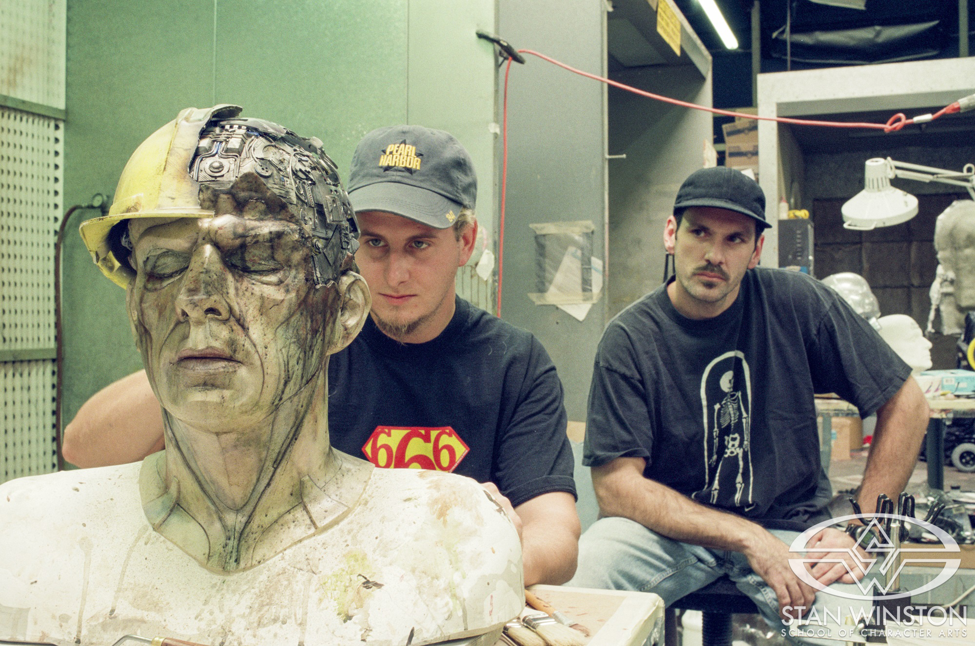 Alan Scott and Scott Stoddard work on one of the Road Worker Mechas.