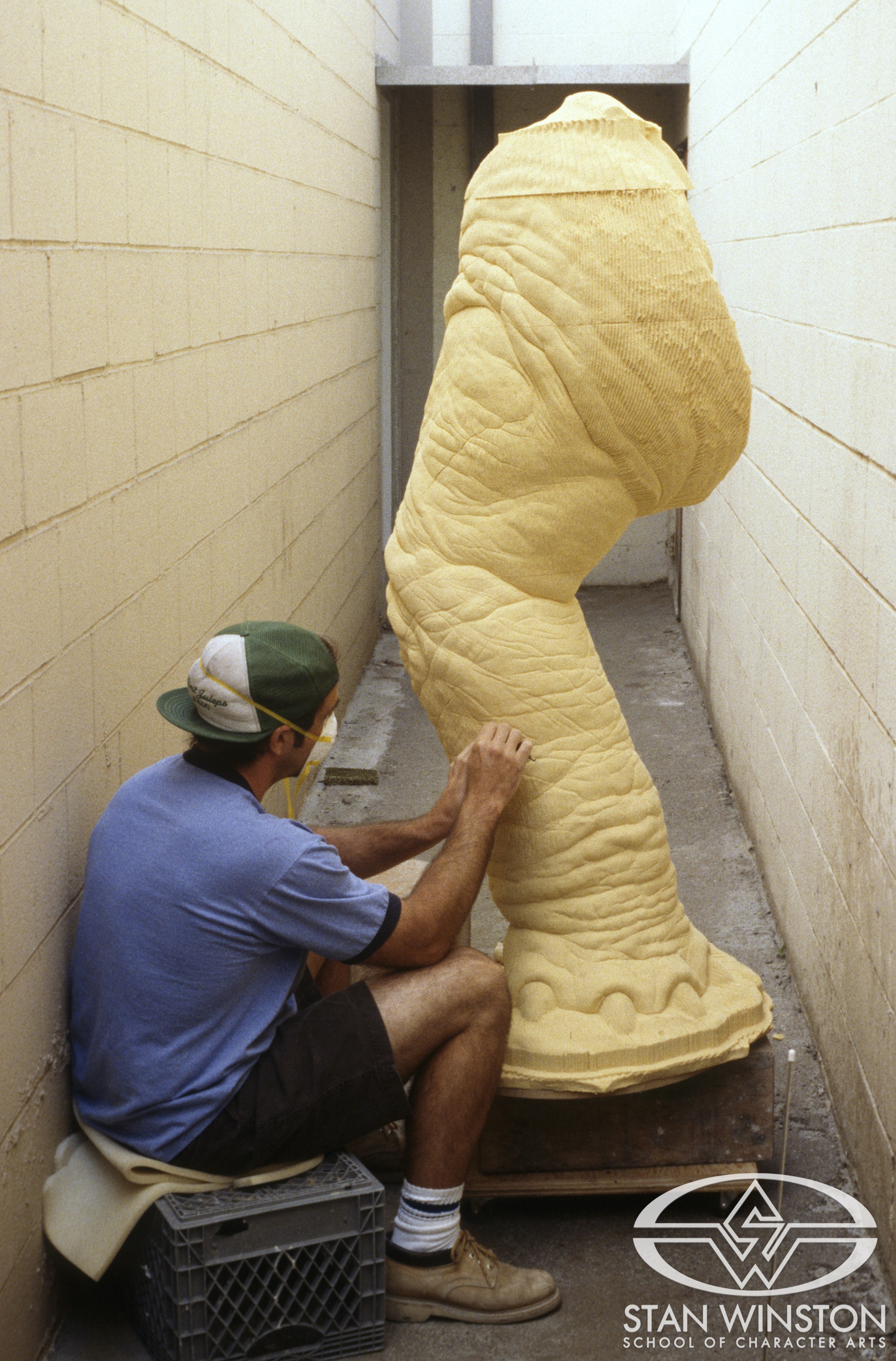 Rob Ramsdell cleans out and carves details of one of the computer-milled foam legs of the adult Stegosaurus.