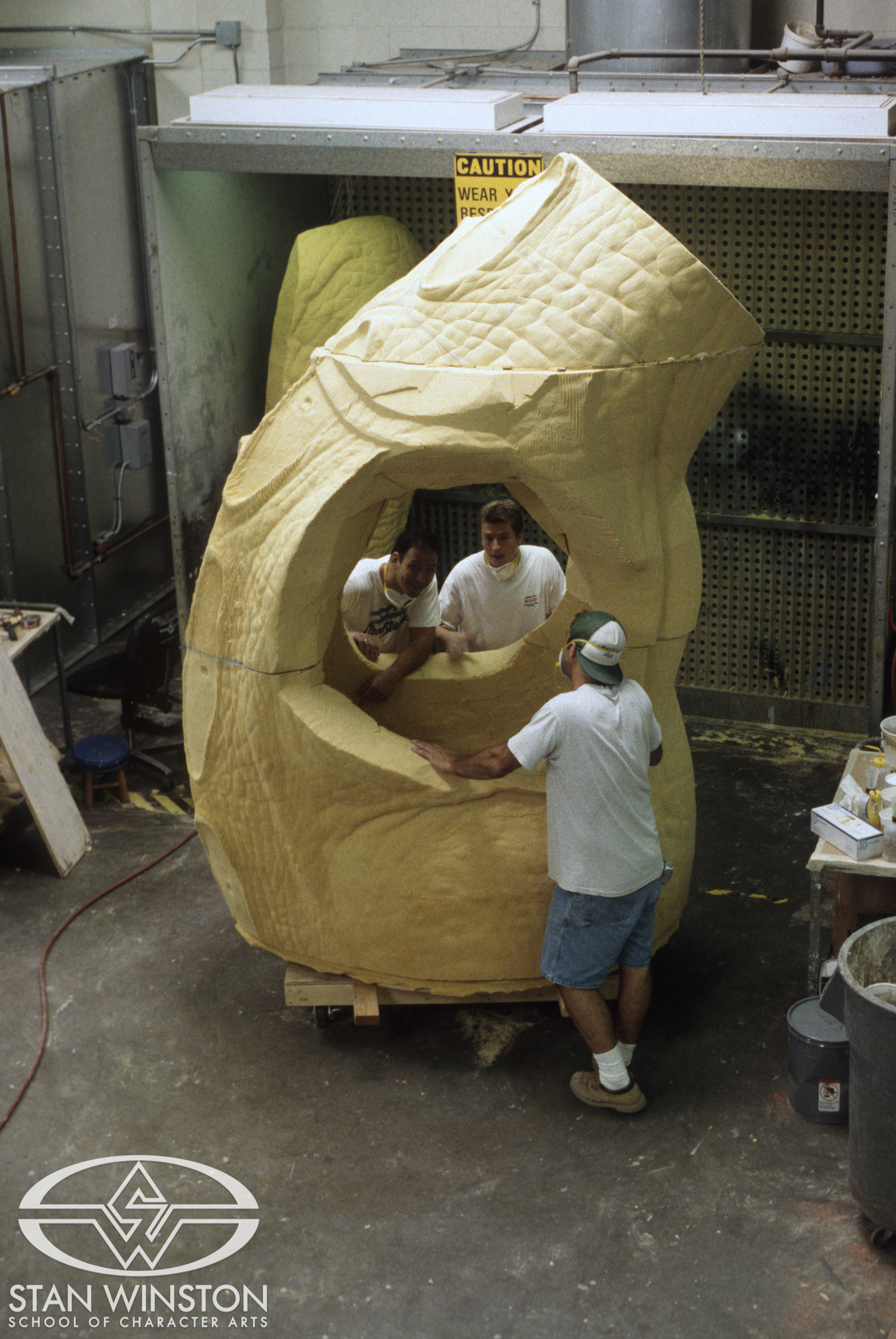 Jim Charmatz, Mark Maitre, and Rob Ramsdell next to the&nbsp;adult Stegosaurus' computer-milled full-sized foam body