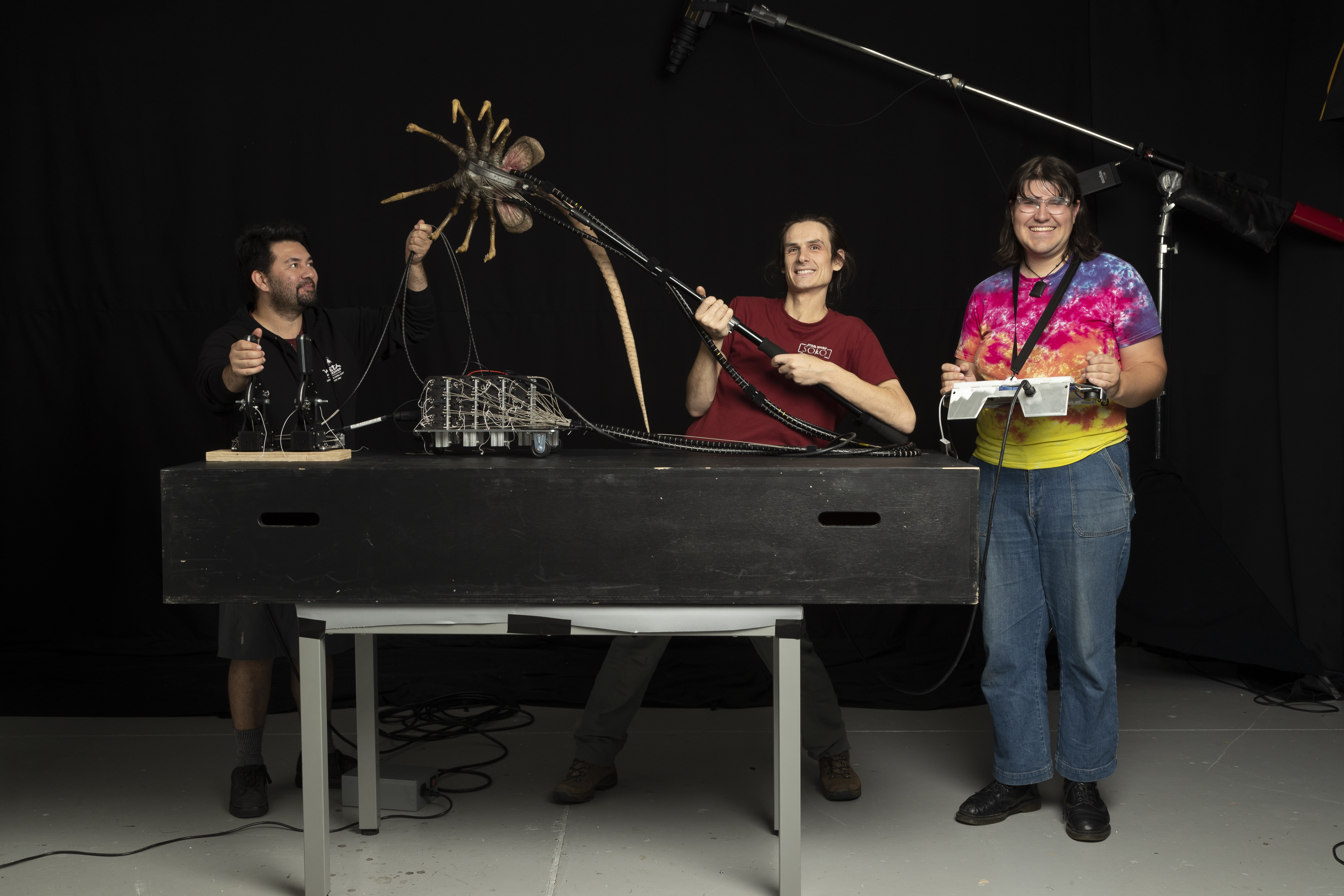 Ra Smith, Joe Harlow, and Omelia Lliffe puppeteer a facehugger with a combination of cable control, rod puppetry, and RC-driven servos. Image courtesy&nbsp;Wētā Workshop.