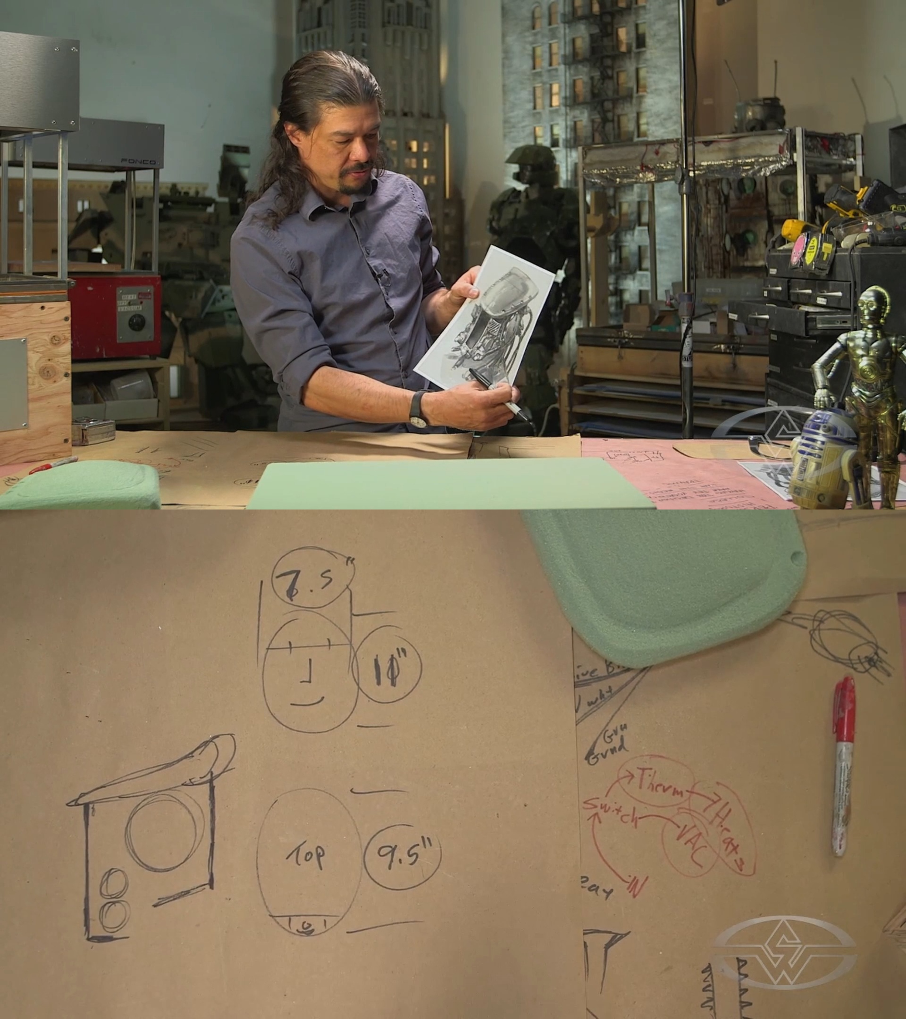 op: Davis holding&nbsp;concept art for his sci-fi helmet. Bottom: the schematic with the rough design sketched alongside.