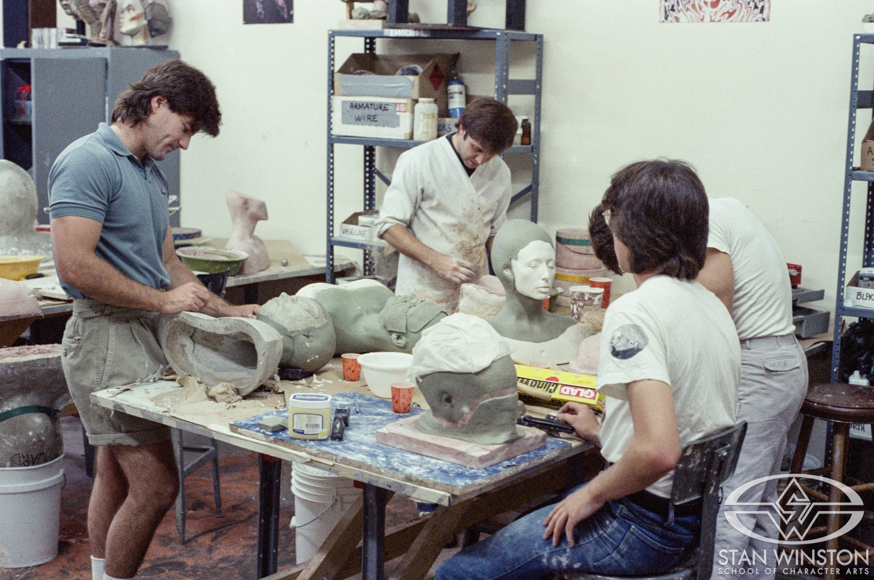 Alec Gillis, Grant Arndt, John Blake, and Jon Curtis Price II work on the newcomers' features in clay over the lifecasts at SWS.