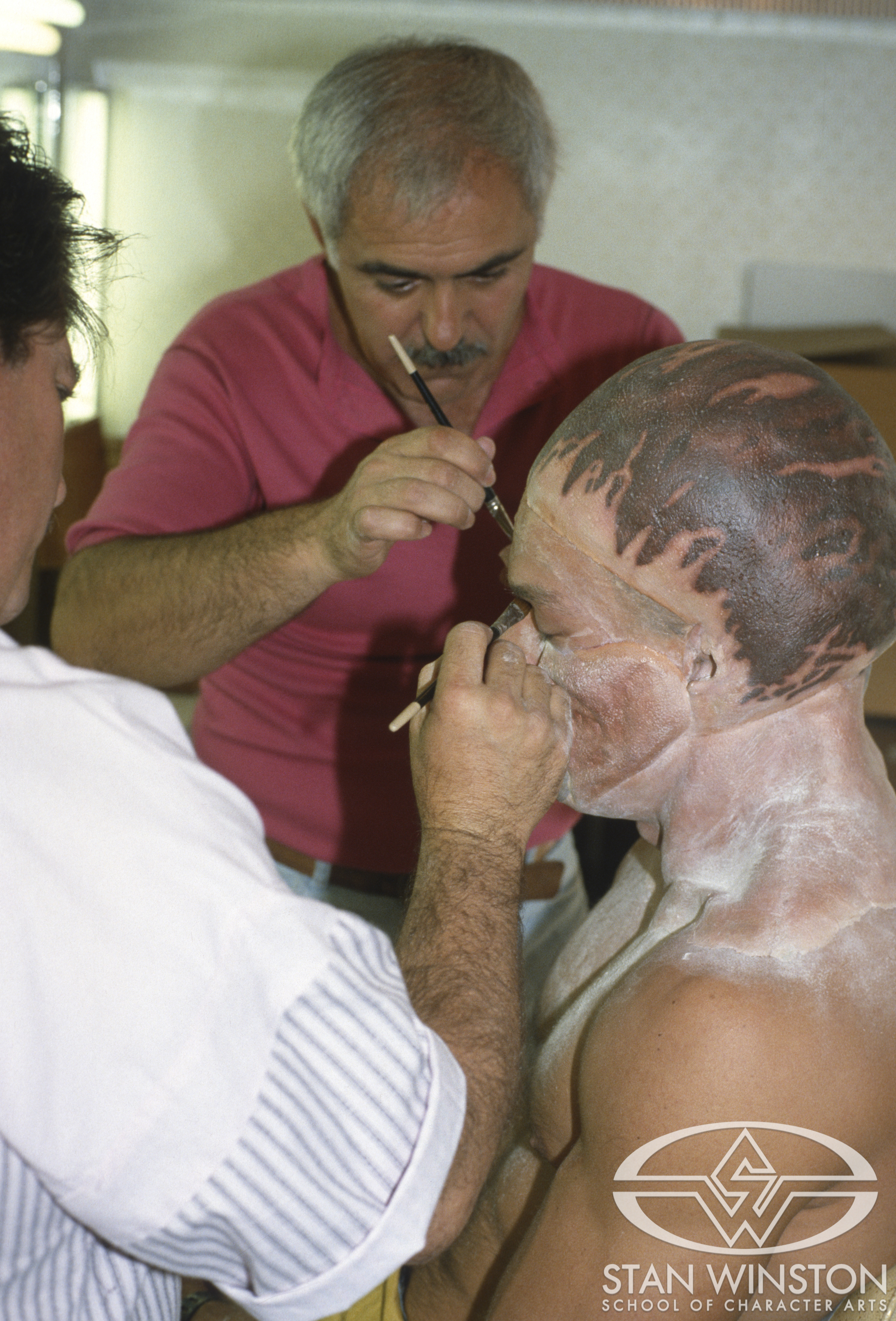 Brian Thompson and Elek Zoltan apply individual alien makeup appliances.
