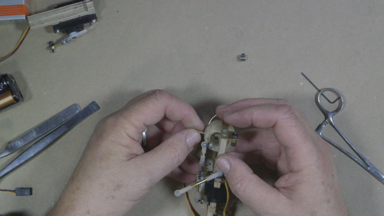 Caton-Largent runs the axle through the brass tubing&nbsp;inside the wood base.