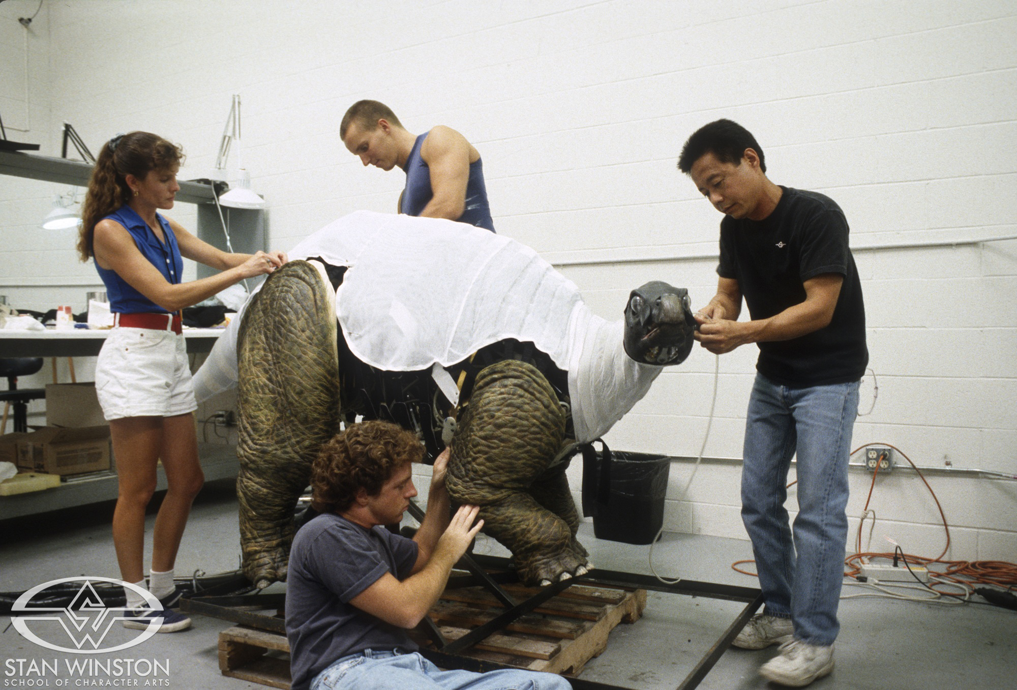 From L to R: Judy Bowerman, Christian Lau, David Grasso, and Bob Mano covering the baby stego animatronics before attaching its skin.