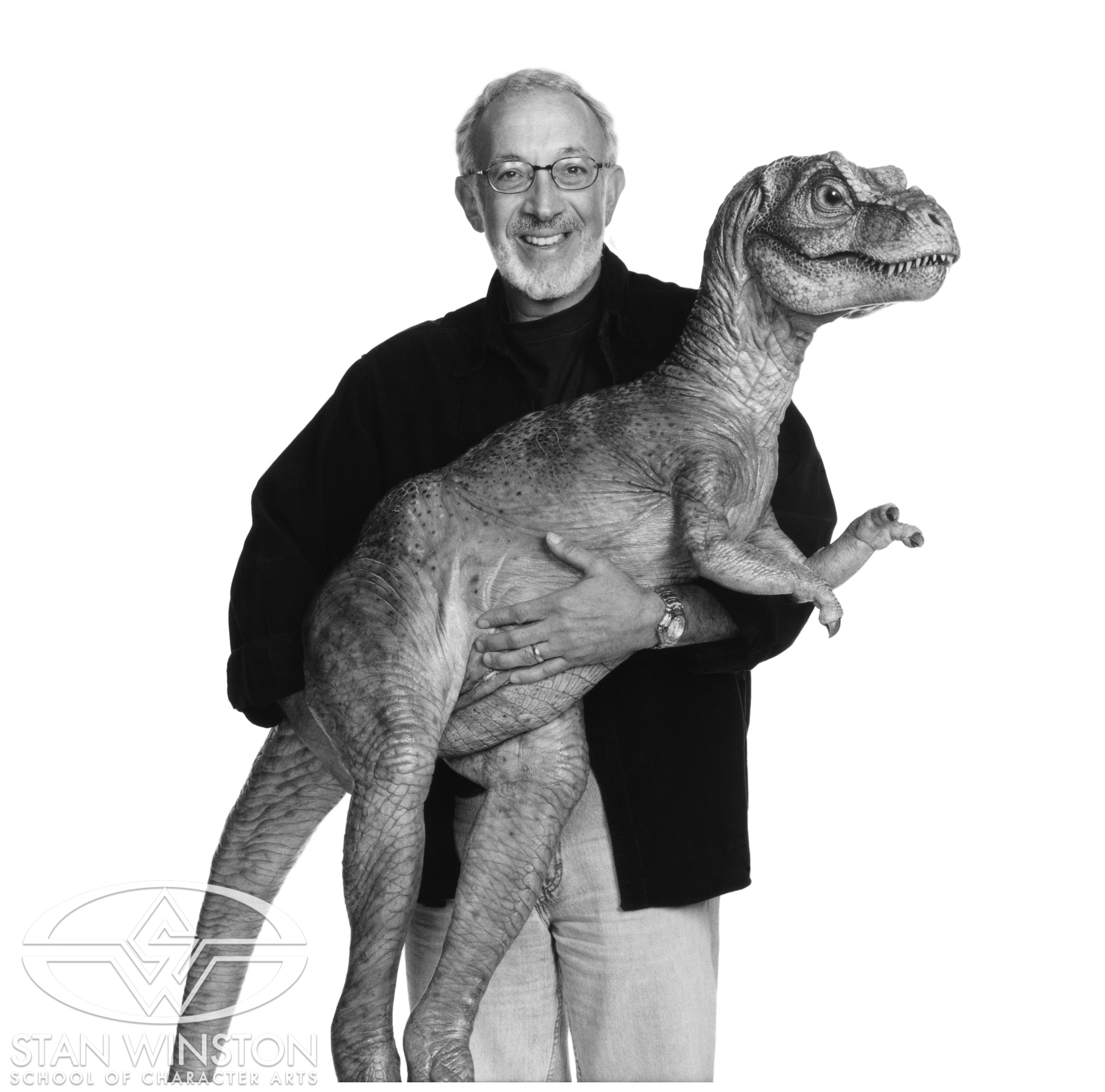 Promo image of Stan Winston with the baby&nbsp;T-rex.