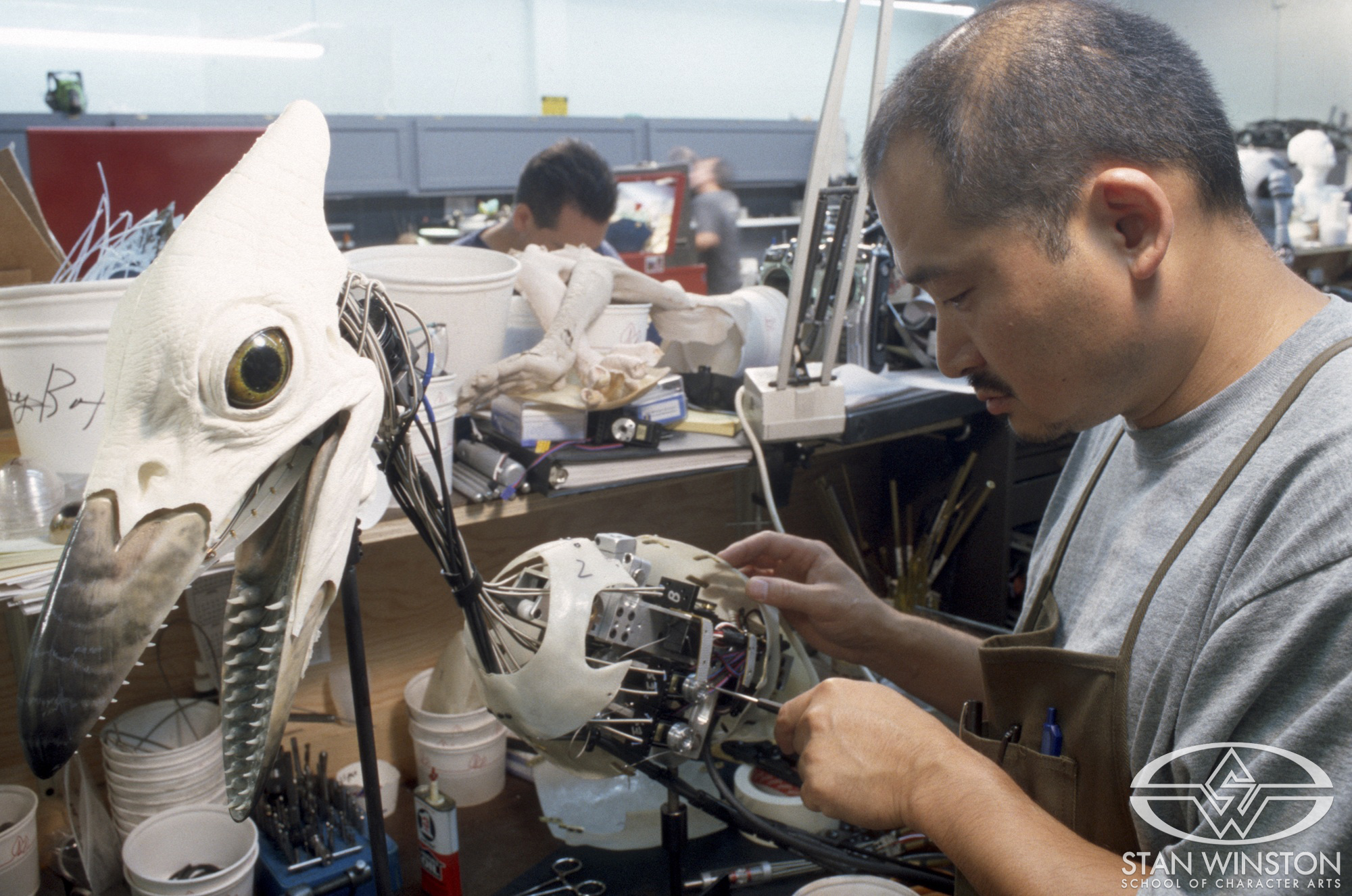 Hiroshi 'Kan' Ikeuchi works on the baby Pteranodon animatronics at Stan Winston Studio.