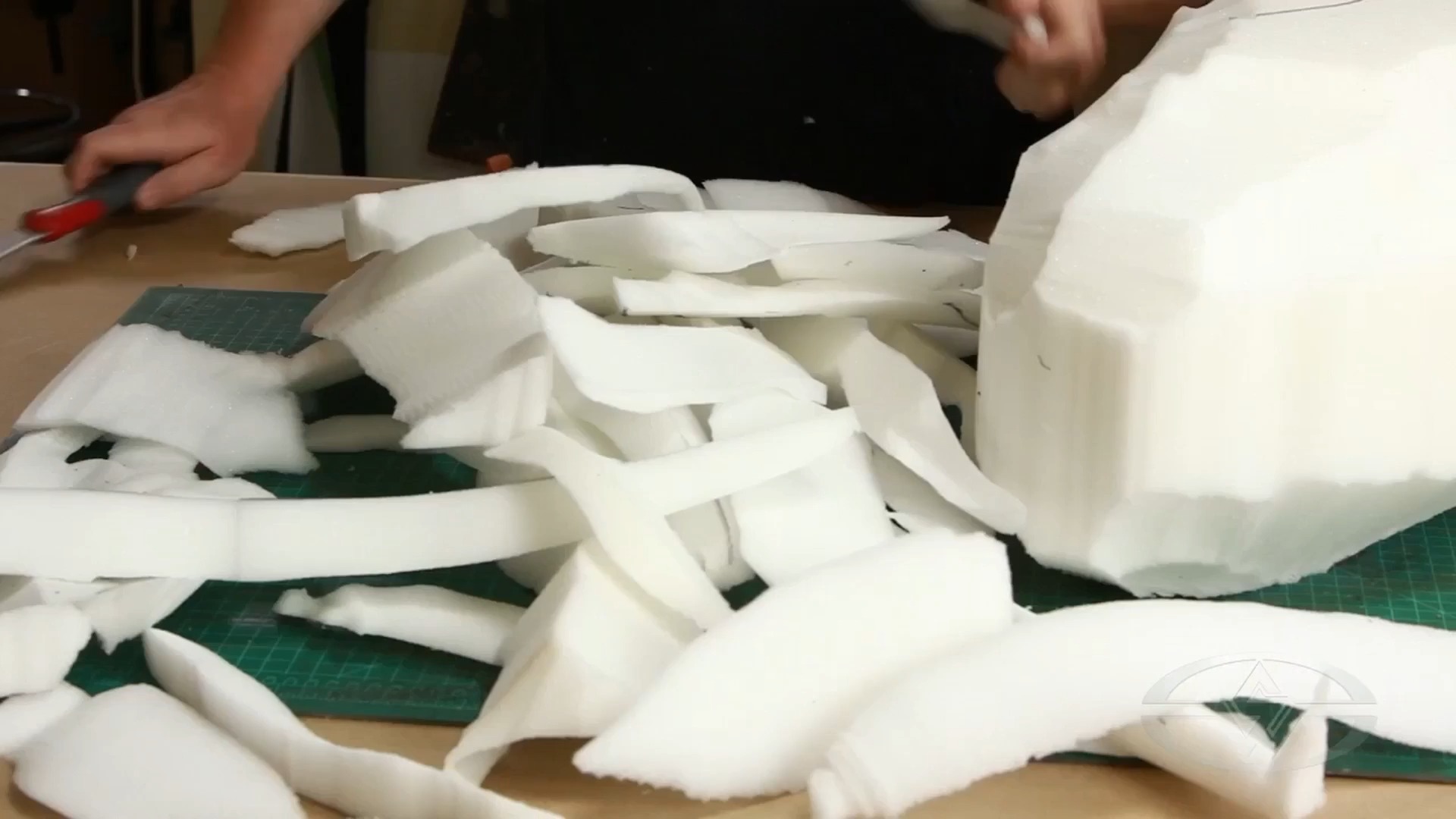 Ted Haines places the amount of foam he's removed so far on his worktable.