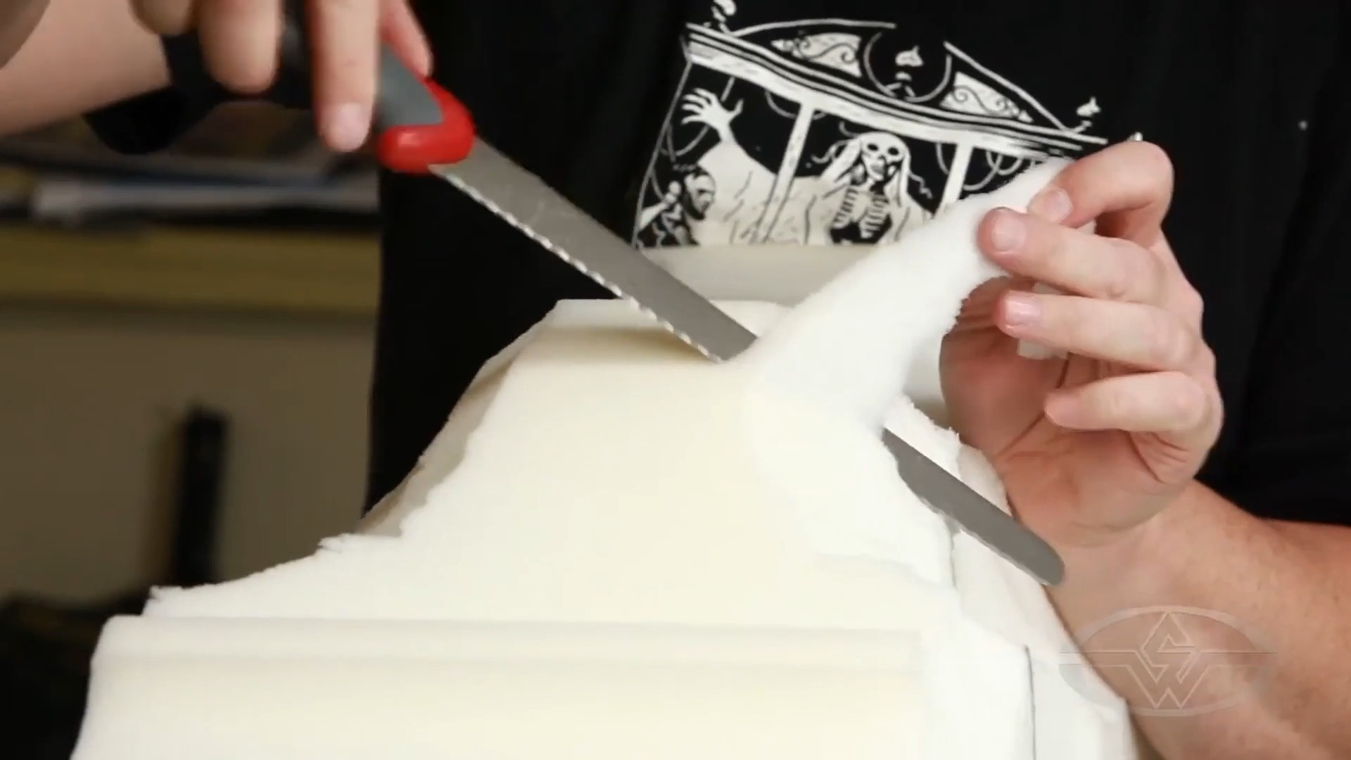 Ted Haines switches from his electric carving knife to a regular carving knife.