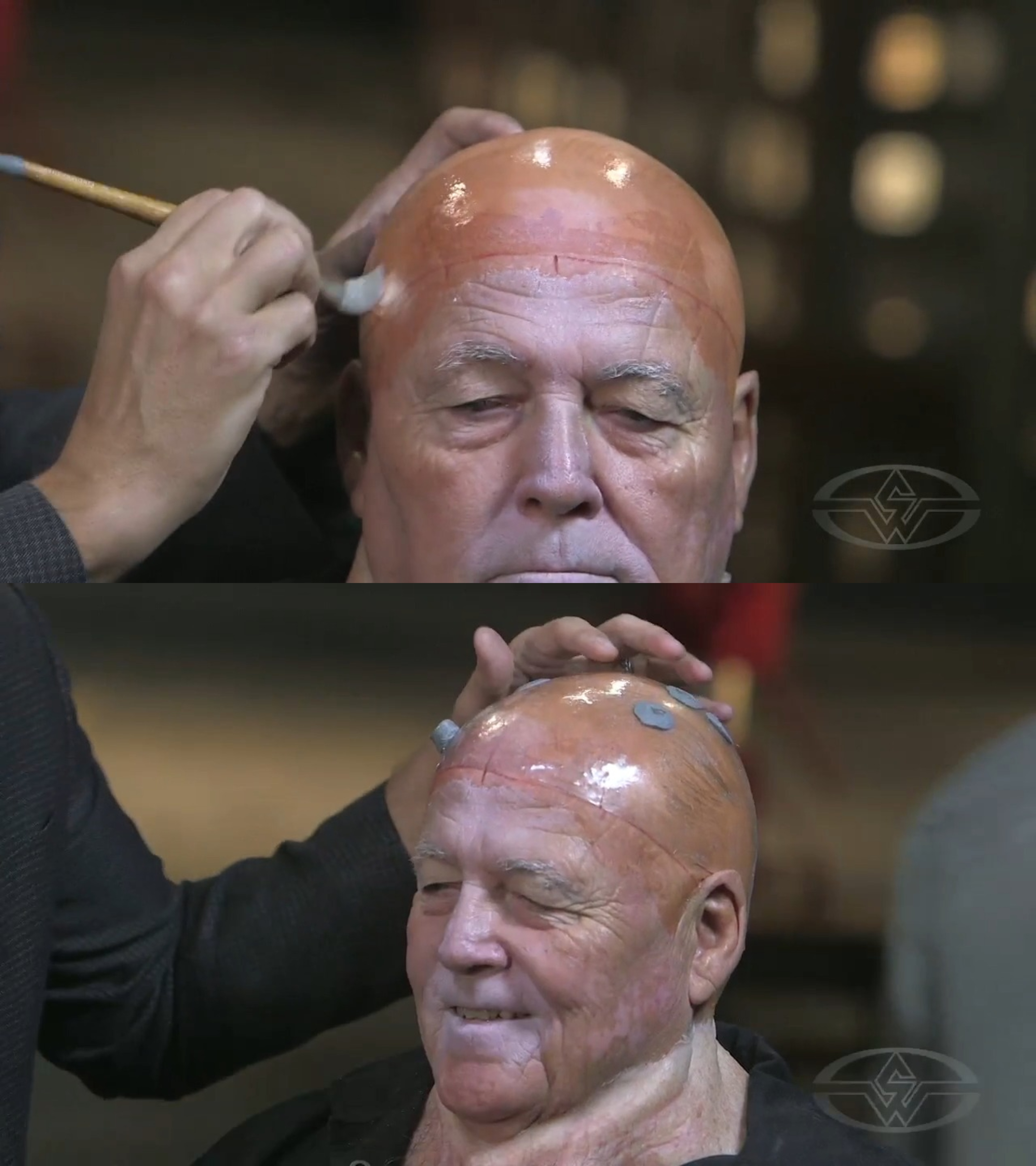 Using a big glue brush, Joel Harlow applies some Pro-Poxy to Charlie Trent's head&nbsp;before placing the vacuform cap on top.