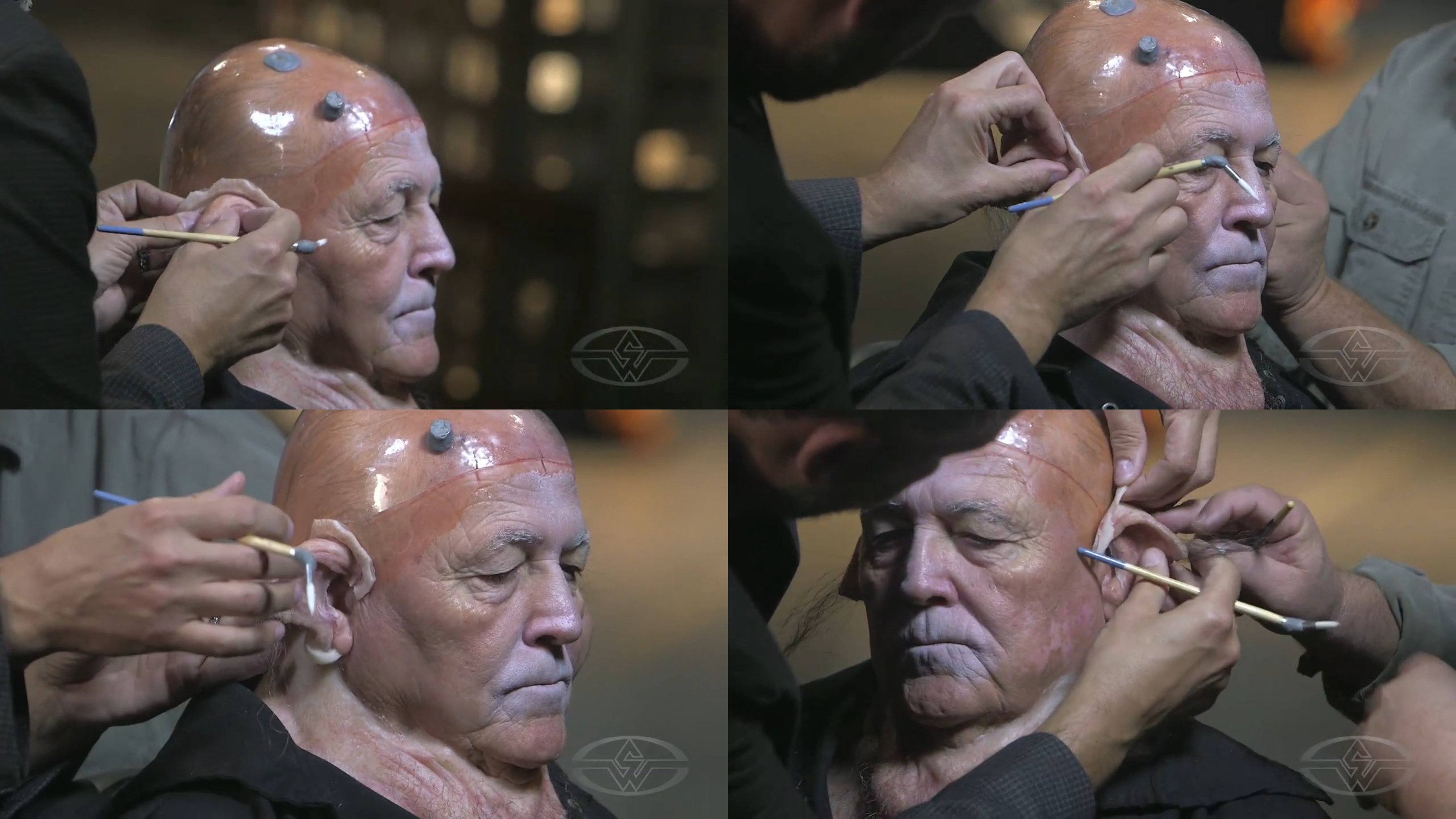 Joel Harlow and fellow artist, Steve Buscaino&nbsp;start applying the prosthetic creature ears over Charlie Trent's ears.