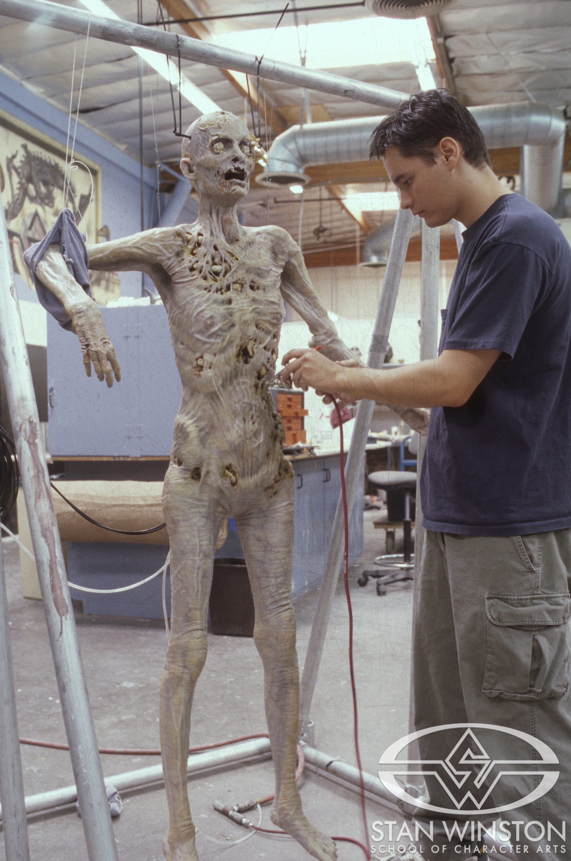 Jason B. Matthews airbrushes the&nbsp;'Horrible Madison'&nbsp;puppet at Stan Winston Studio.