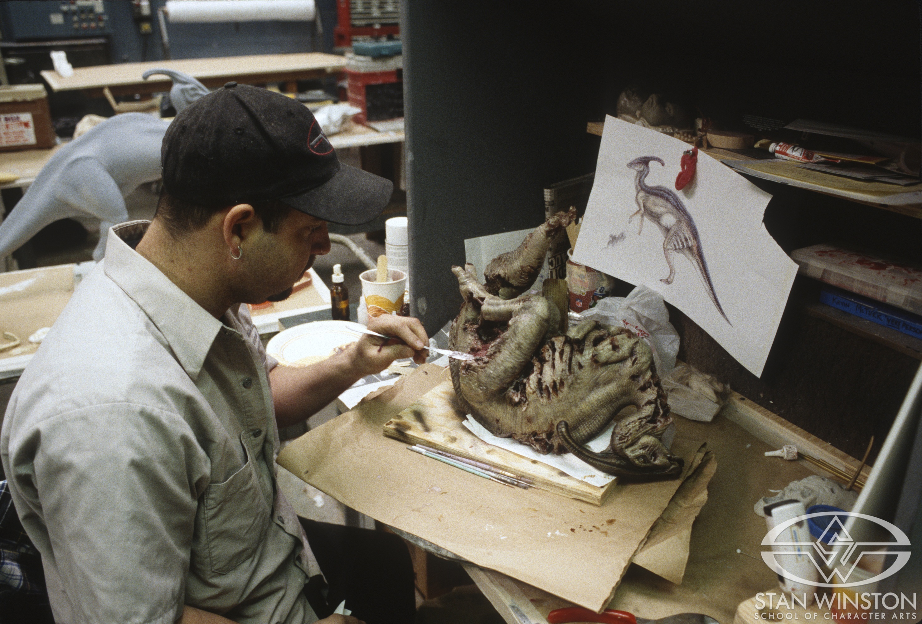 Tim Gore works on the miniature silicone maquette of the dead Parasaurolophus.