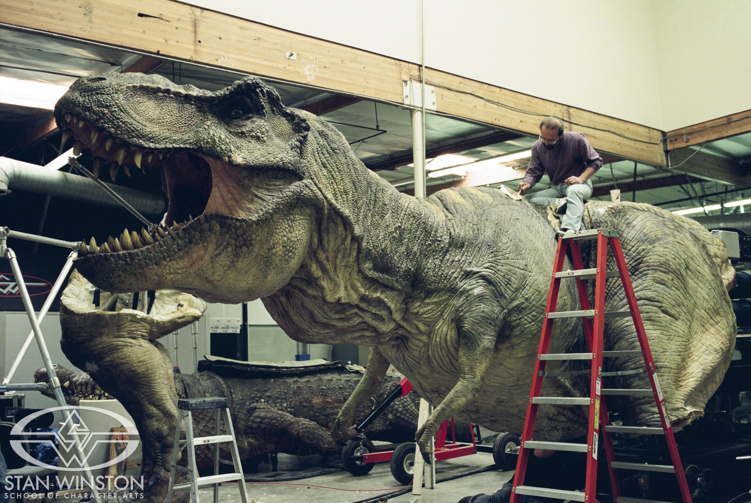 Joe Reader works on the foam latex skin&nbsp;on&nbsp;the life-size male T-Rex's animatronics.