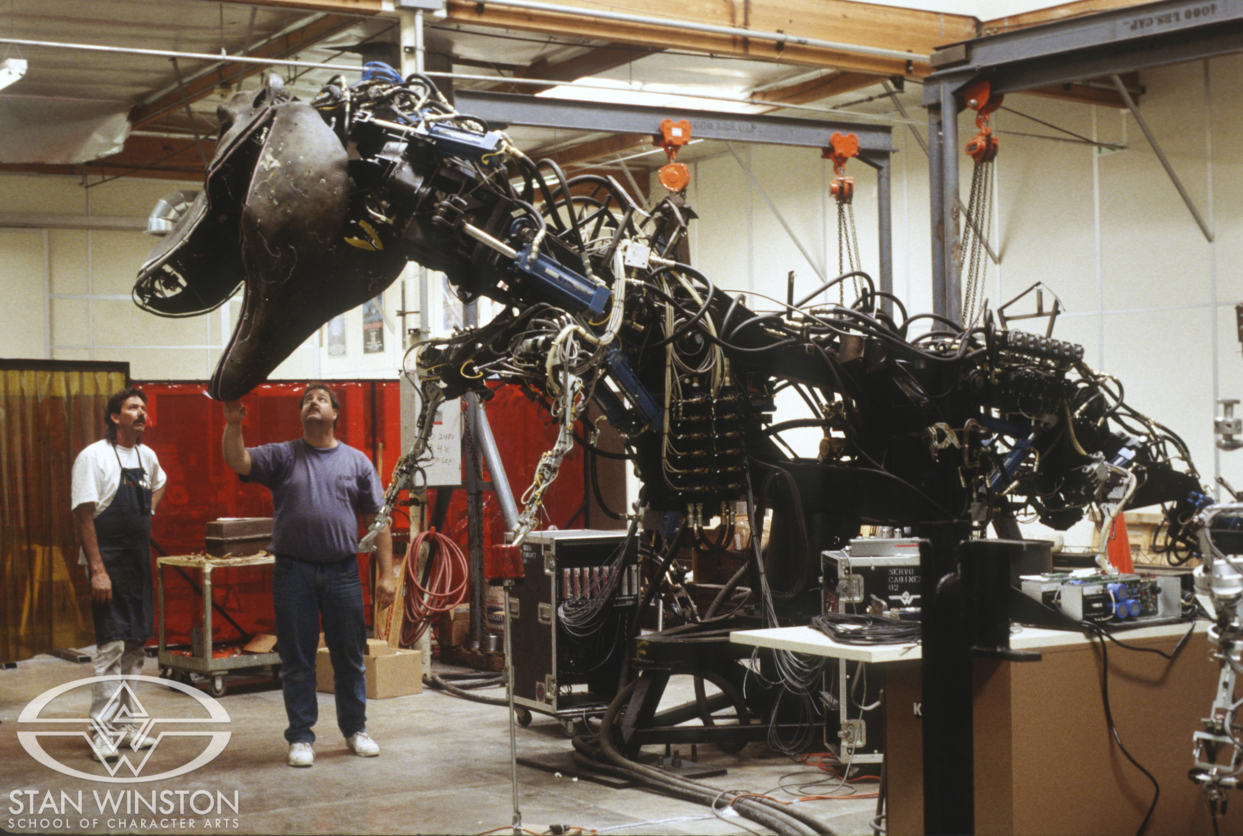 Tim Nordella and another artist oversee&nbsp;the male T-Rex's&nbsp;head and neck mechanism at Stan Winston Studio.