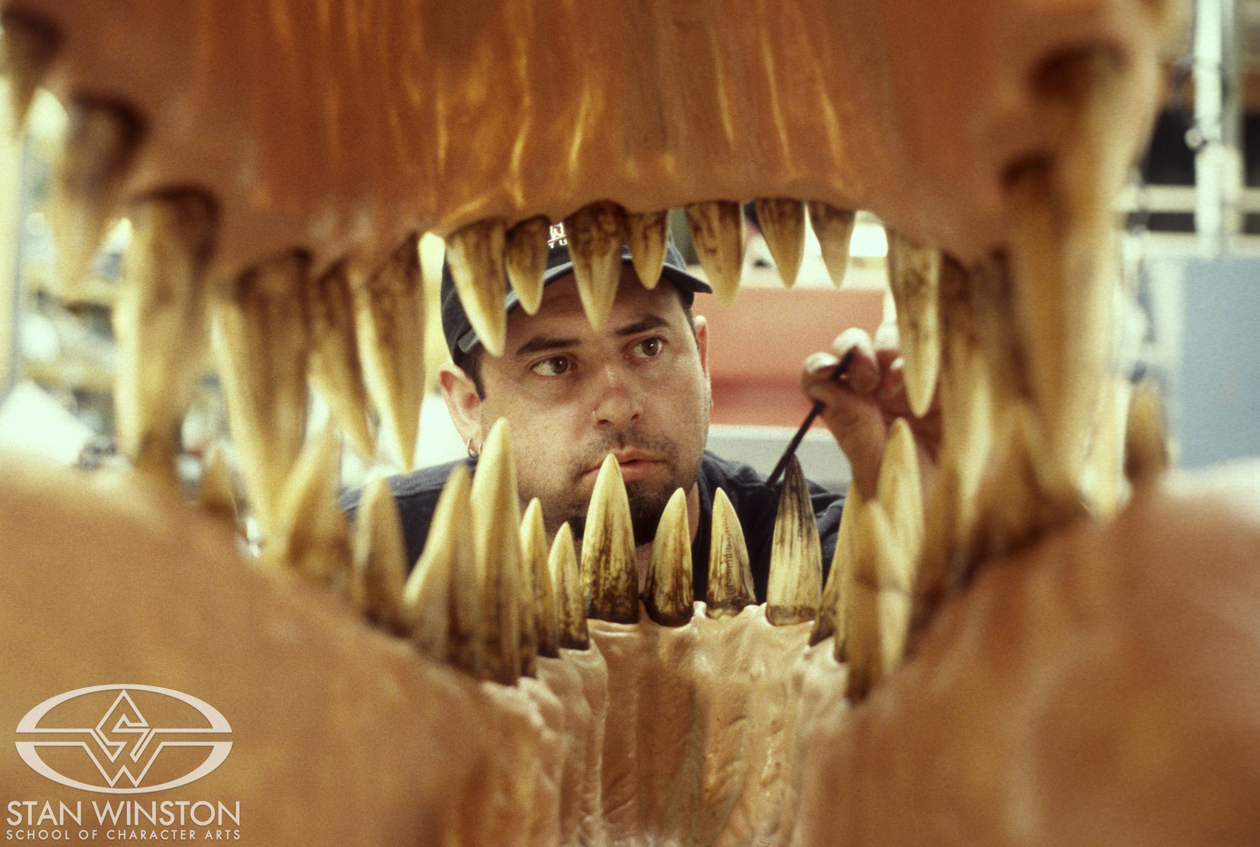 Tim Gore paints the life-size T-Rex teeth at Stan Winston Studio.
