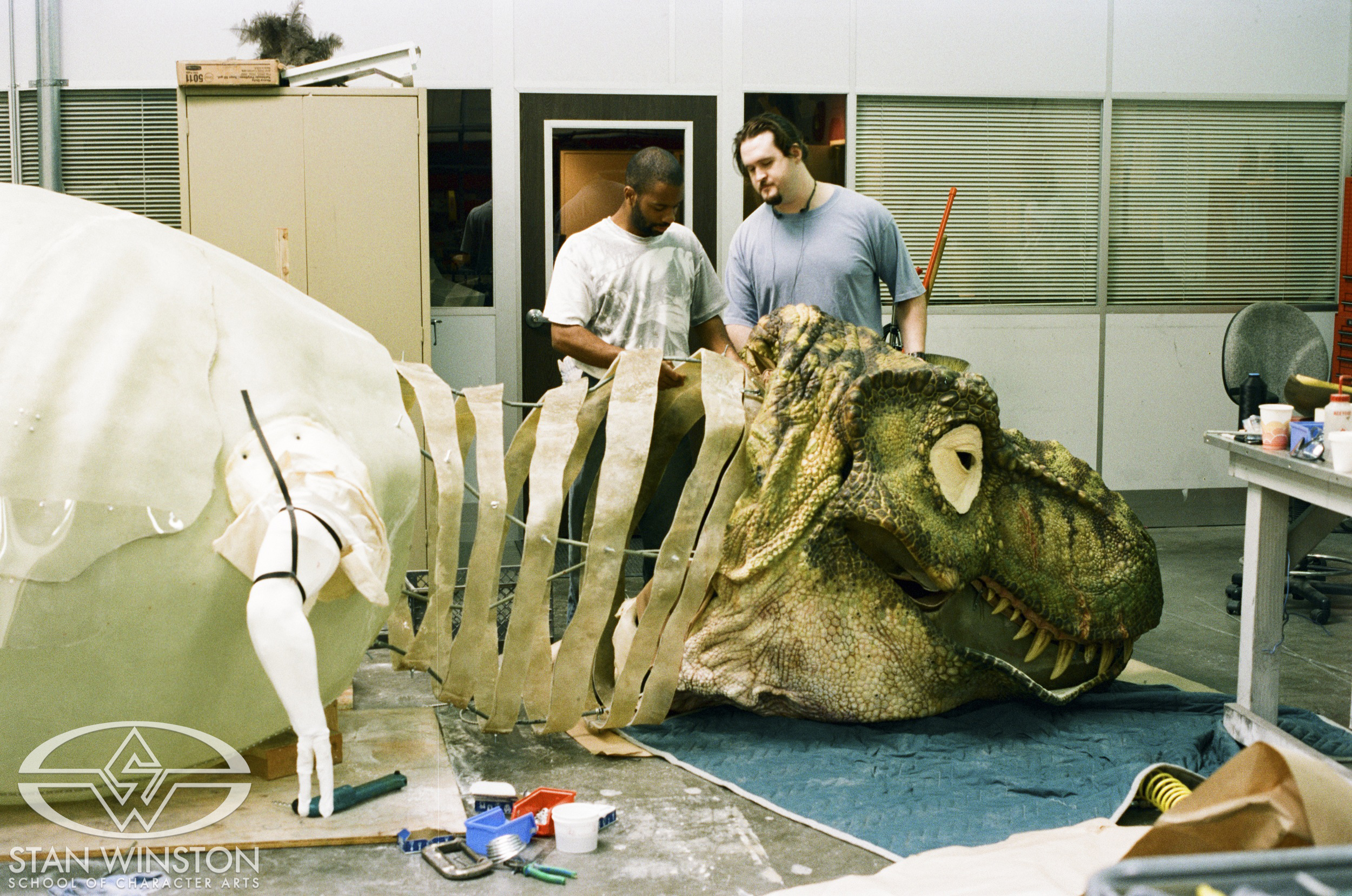 Lance Gilmer and Trevor Hensley test-fitting the male T-Rex head's foam latex skin.