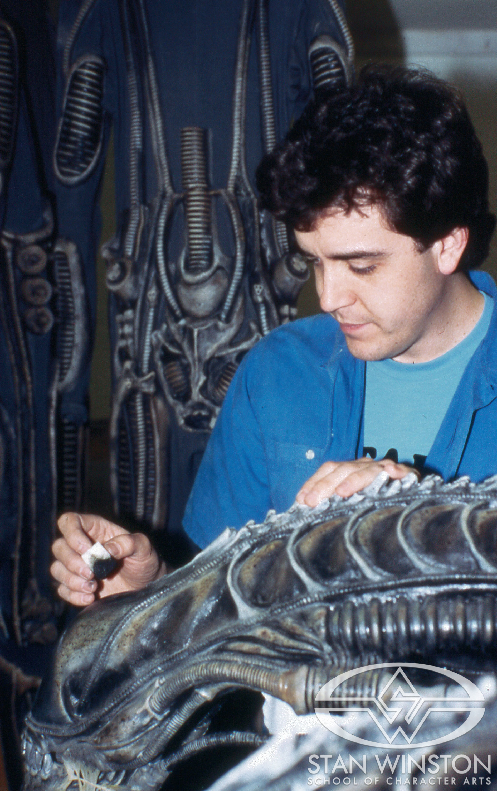 Tom Woodruff Jr. paints one of the alien warrior heads at Pinewood Studios.