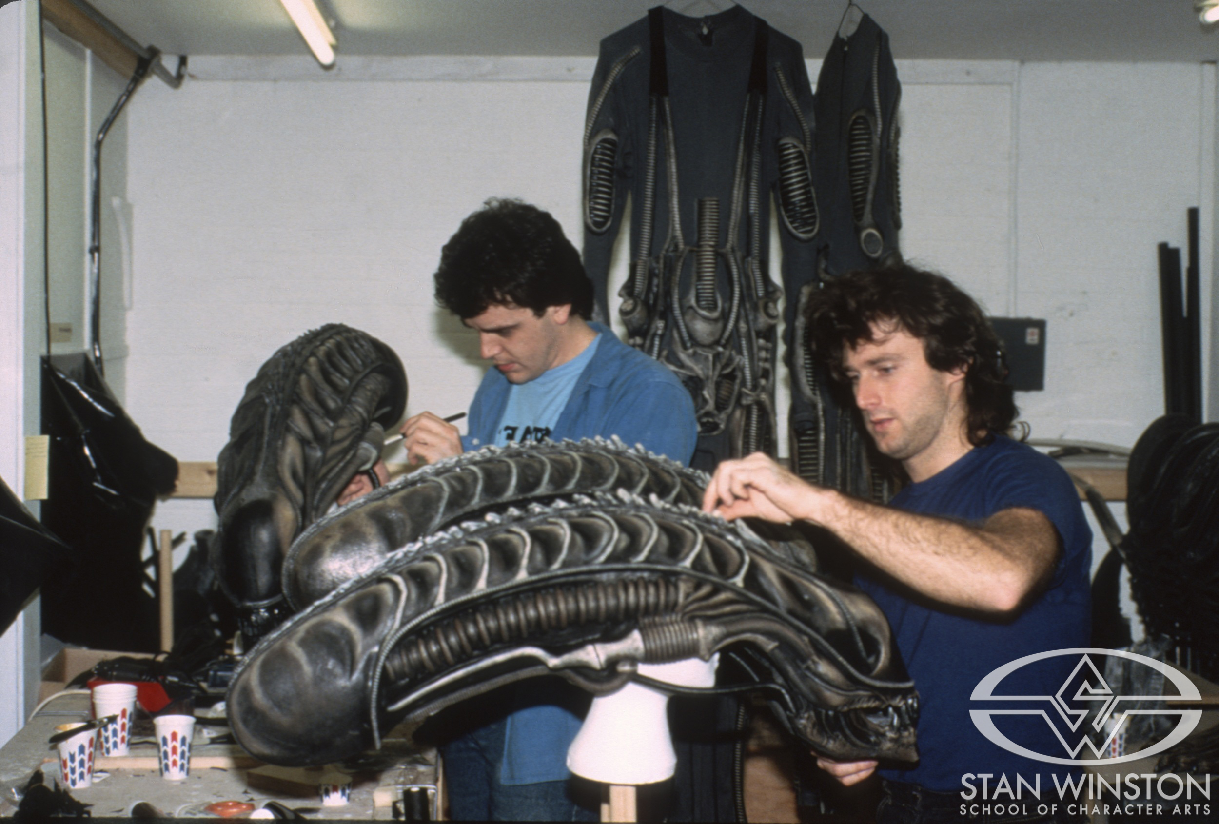 Tom Woodruff Jr. and John Rosengrant paint xenomorph heads at Pinewood Studios.