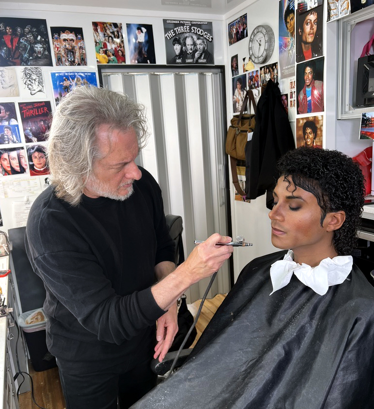 Bill Corso using an airbrush to refine the details of the Michael Jackson makeup on Jaafar Jackson. Image courtesy Bill Corso/Lionsgate.