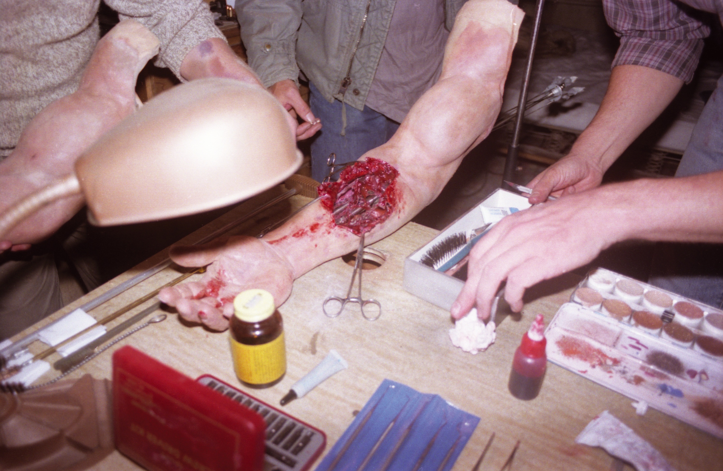 Stan Winston's crew prepare the&nbsp;dummy arm for the arm surgery scene.&nbsp;Image courtesy of Hemdale Film, Pacific Western Productions, Euro Film Funding, and Cinema '84.