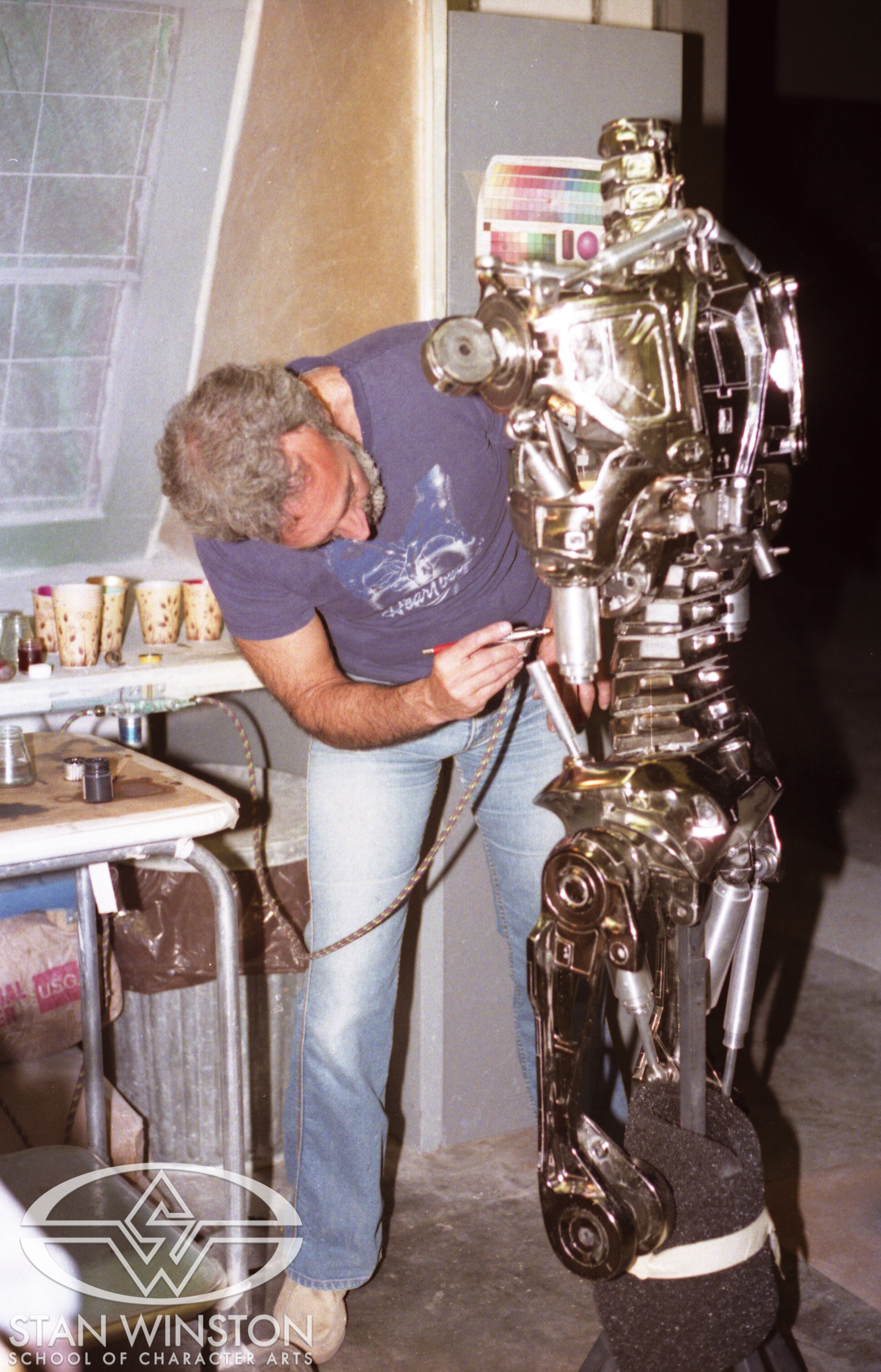 Stan Winston airbrushes a Terminator endoskeleton.